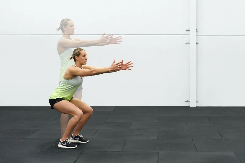 A young athlete performing a shallow double-leg squat for Osgood Schlatter knee pain