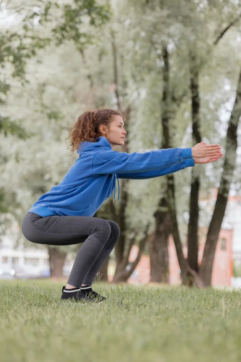 Woman doing squats as part of her Osgood treatment program