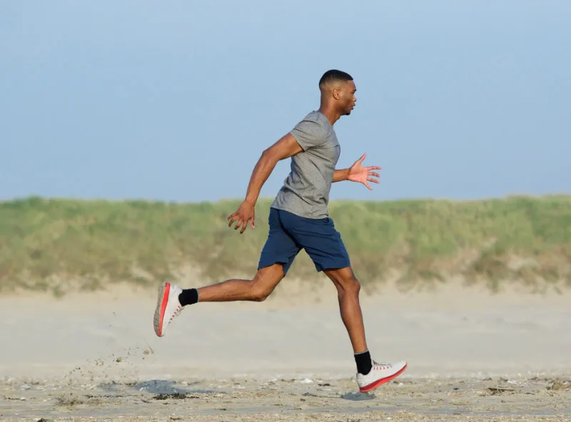 Young athlete running with a heel strike
